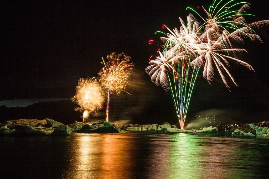 Illuminated icebergs bathed in colour from the magnificent firework show