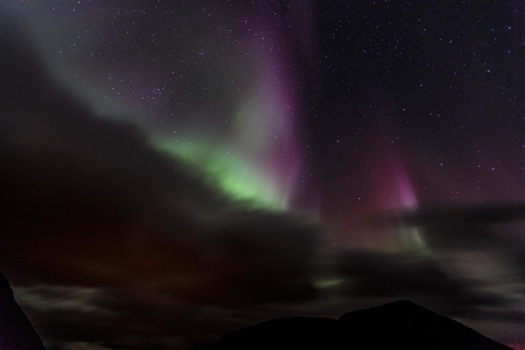 The dancing lights peeking from behind the mountains